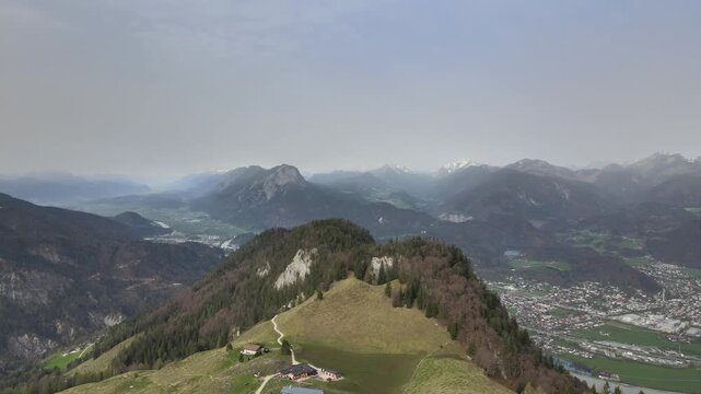 Aerial drone footage of panoramic mountain view over alpine foothills and distant valley landscape