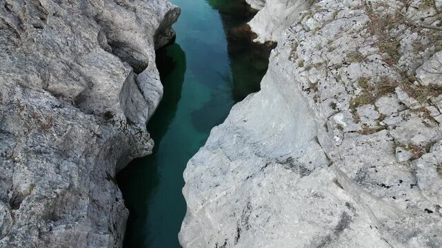 Aerial drone footage tilting from top down view of Soča river canyon to scenic alpine landscape in Slovenia