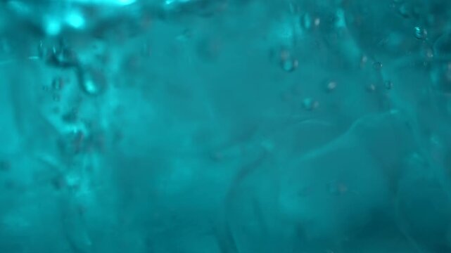 Close up of ice cubes underwater with oxygen bubbles, frost patterns, and soft light reflections. Concepts for beauty advertising, menu designs for bars and restaurants, cryotherapy.