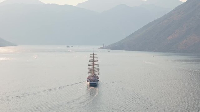 Mast of vintage Sail cruise ship in the bay of Kotor at sunset, aerial view