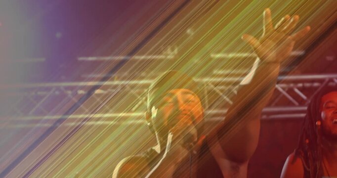 Singer moving into center after diagonal light cue, raising arm, leaning into mic, during concert