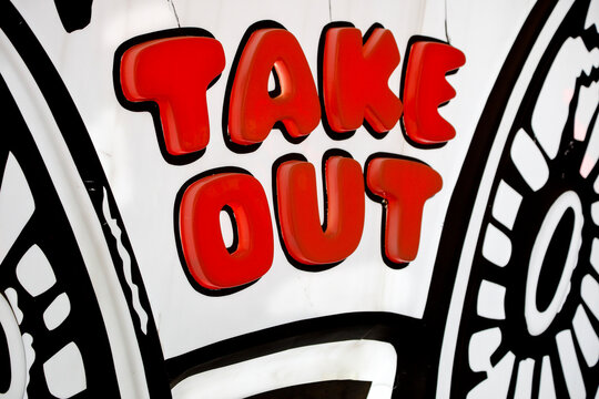 Bold &ldquo;Take Out&rdquo; text on graphic sign, food and takeaway concept