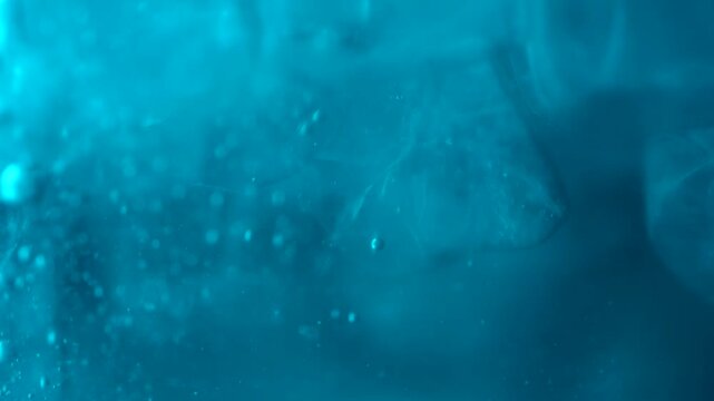 Close up of ice cubes underwater with oxygen bubbles, frost patterns, and soft light reflections. Concepts for beauty advertising, menu designs for bars and restaurants, cryotherapy.