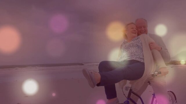 Man starting pedal, senior couple riding shoreline to share warm moment, bokeh lights drifting