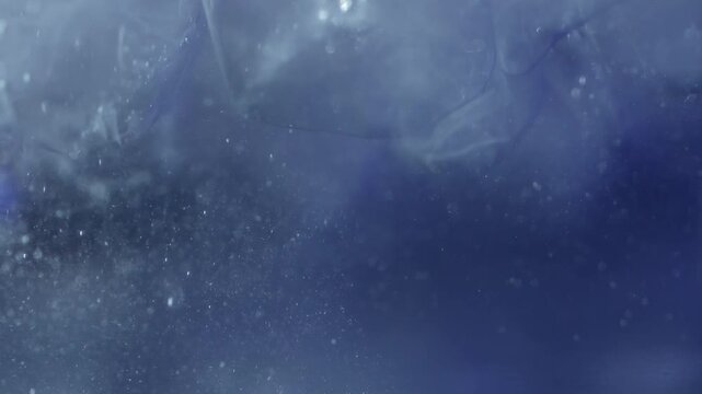 Close up of ice cubes underwater with oxygen bubbles, frost patterns, and soft light reflections. Concepts for beauty advertising, menu designs for bars and restaurants, cryotherapy.