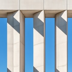 Obraz premium Geometric Rhythm Vertical concrete structures bathed in sharp light and shadow, revealing a minimalist abstract pattern against clear blue sky. Architecture, Abstraction