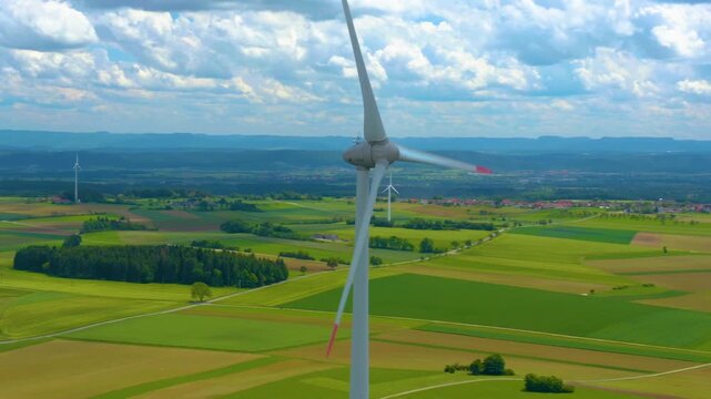 Aerial view of a wind turbine close to the Black Forest in Germany with a parallax  pan on a sunny day.