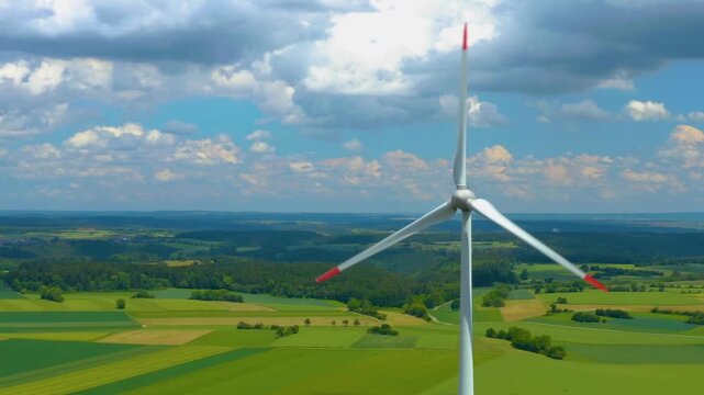 Aerial view of a wind turbine close to the Black Forest in Germany with a parallax  pan on a sunny day.