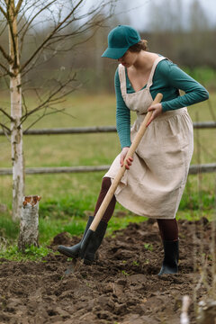 Woman gardening with spade in an open field