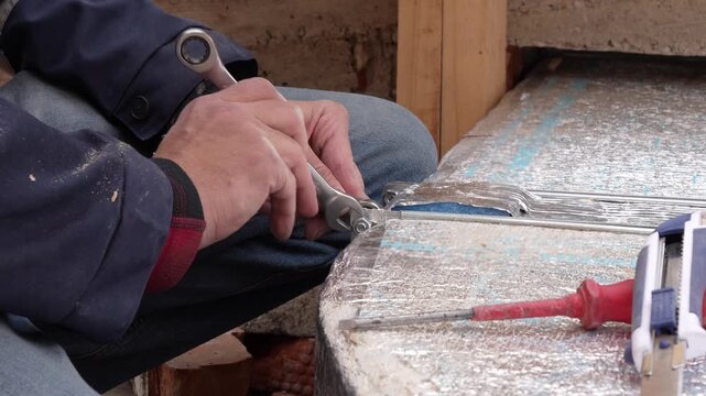 HVAC Worker Assembling Ventilation Ducts with Wrench Tightening Bolts 4K