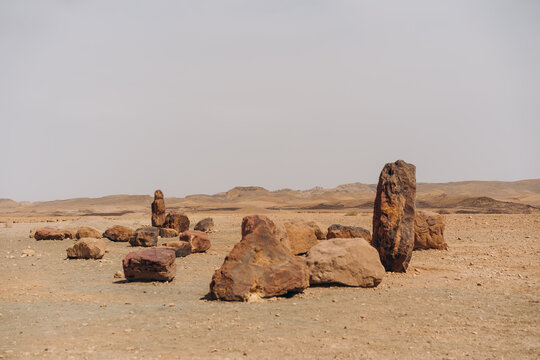 Standing geological rock formations and scattered stones in Negev desert near Mitzpe Ramon