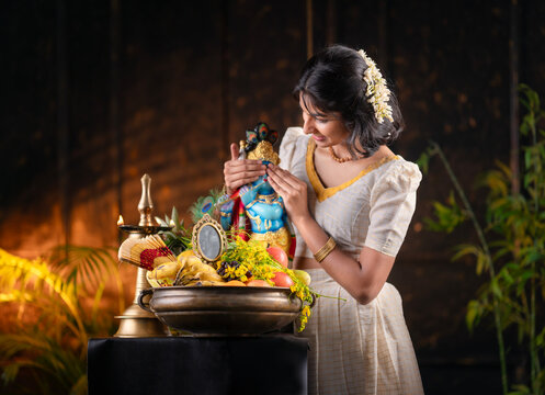 Vishu Kani festival photo Kerala girl wearing traditional dress and sanding near Vishu Kani