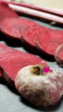 Vertical video: Camera panning right over food beets on slate sparking social icons stacking counts