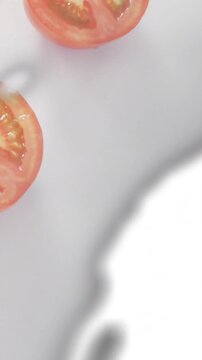 Vertical video: Tomato entering top-left, camera pulling, silver wipe sweeping, showing teal print