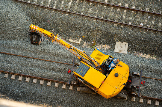 Top view of rail excavator placing ballast on railway tracks