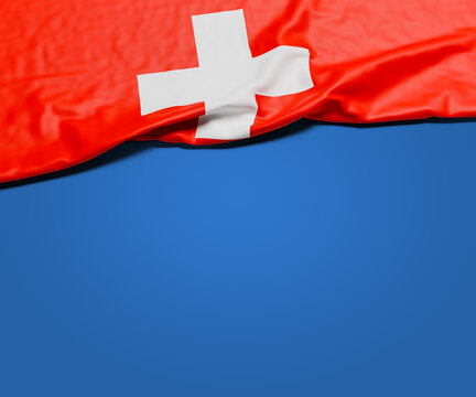 The wrinkled flag of Switzerland draped onto a flat blue background with shadow. Copy space for message