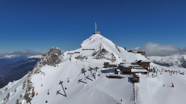 Aerial view of Courchevel and Meribel station in French alps with skiers on the slopes and snowcapped mountains by winter