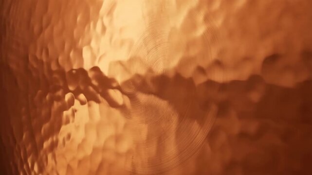 Gong copper hammered texture with concentric circles, macro shot, abstract background, warm metallic surface, detailed.
