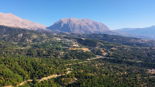 Aerial panoramic view of Yumru Mountain rising above cedar forests and apple orchards near Kas, Antalya, Turkey