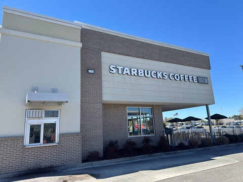 Mobile, Alabama, USA - February 22, 2026: Drive-thru Starbucks cafe in Mobile Alabama with customers and modern building design