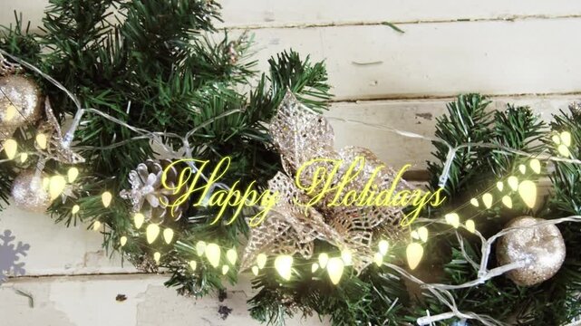 Animation of text, happy holidays, in yellow, over string lights and christmas decorations