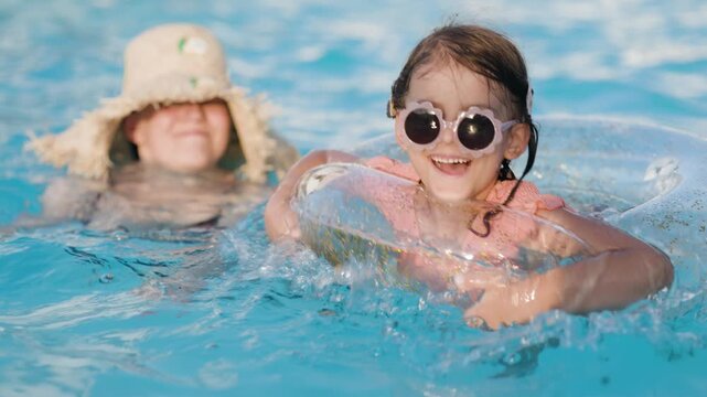 mom and daughter in pool have fun during summer vacation. Child having fun in swimming pool. 