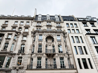 Fototapeta premium Elegant historic stone building facade with ornate balconies in central London, UK city street