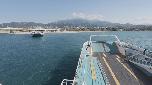 Harbor scene from ferry deck with ships starting journey together