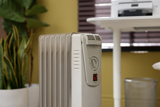 Modern portable electric heater in room, closeup