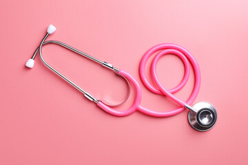 Fototapeta premium One stethoscope on pink background, top view