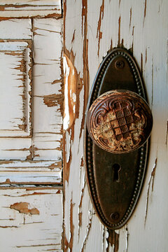 Old door knob on weathered wooden door, vintage texture detail