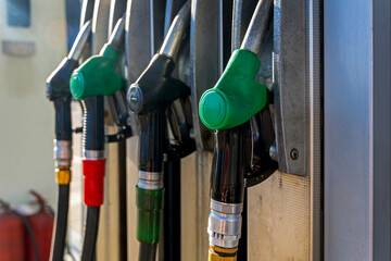 Fuel Pump Nozzles at Modern Gas Station. Close-up of fuel pump nozzles at a gas station, highlighting gasoline and diesel dispensers, energy supply, transport, and refueling. © Iryna