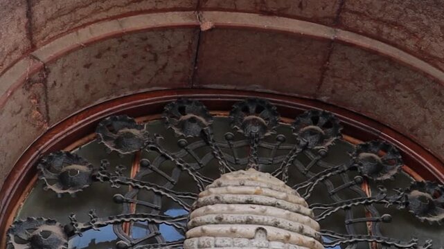 Intricate Art Nouveau Iron Grille and Stone Arch Detail