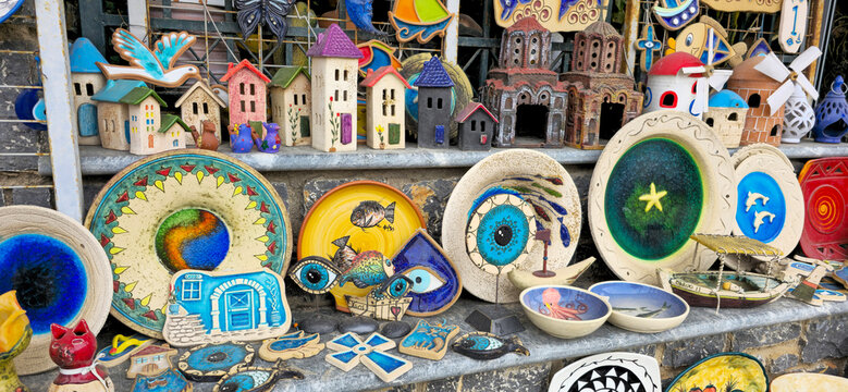 Colorful handmade ceramic souvenirs displayed in a local gift shop on Chios Island Greece featuring traditional pottery designs and vibrant decorative items