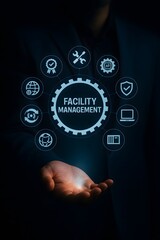 Fototapeta premium Facility management concept with businessman holding holographic system icons for building maintenance and operations
