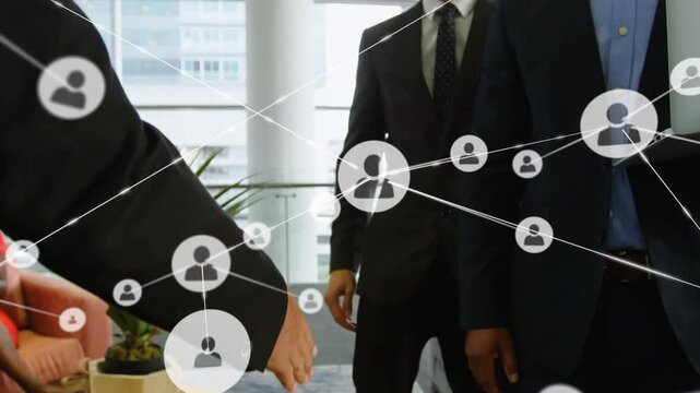 Animation of connected icons with lines, diverse business people with laptop shaking hands in office