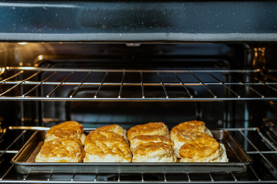 Biscuits on a baking sheet in an oven 