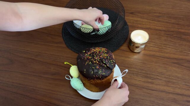 Woman decorating traditional easter cake with chocolate icing