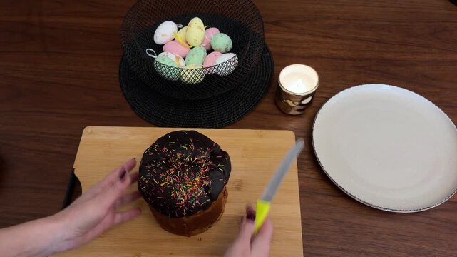 Woman's hands slicing traditional easter cake