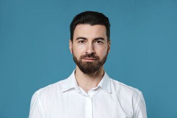 Obraz premium Portrait of handsome man on light blue background