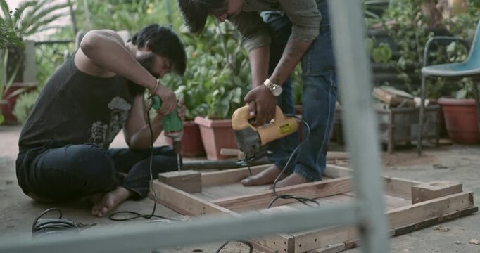 Beginner carpenter using professional tools while working on wood, capturing real workshop moments and skill development in action