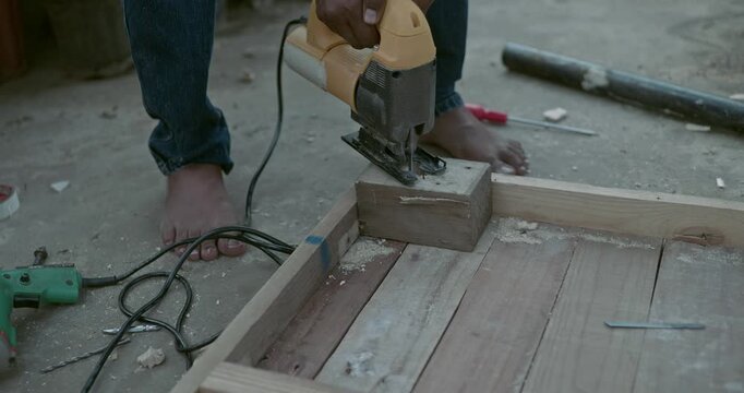 Beginner carpenter using professional tools while working on wood, capturing real workshop moments and skill development in action