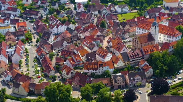 An panoramic aerial view around the old town in the city Waldenbuch on a sunny summer noon in Germany .