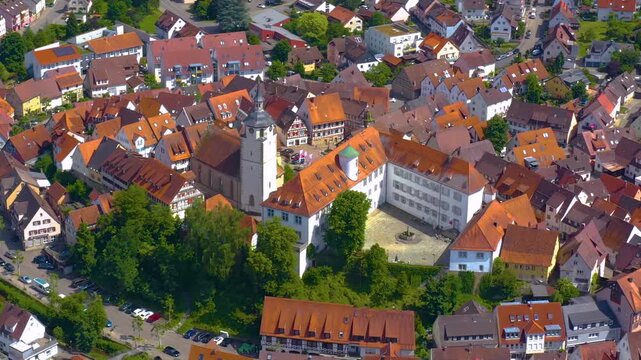 An panoramic aerial view around the old town in the city Waldenbuch on a sunny summer noon in Germany .