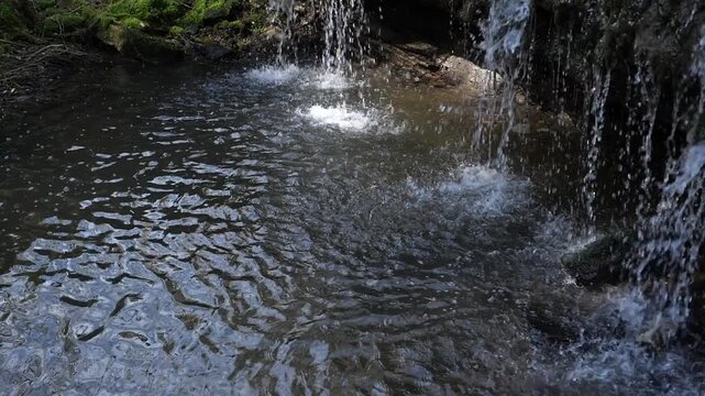 River water waterfall splashing on the river water, slow motion video
