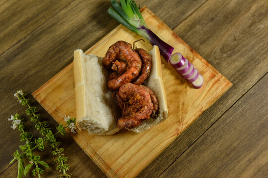 Cow bowels presented on a wooden board with ingredients, ready to grill