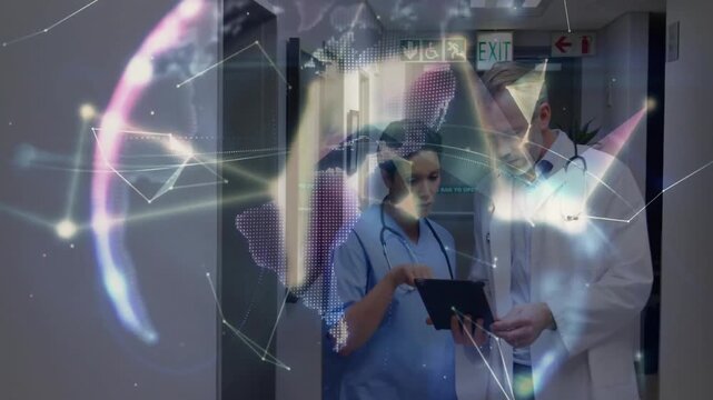 Nurse tapping tablet in hospital hall and showing doctor swirling network forming holographic globe