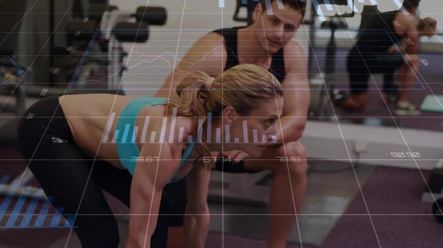 Woman gripping barbell deadlifting on purple mat in gym while trainer guiding form with metrics