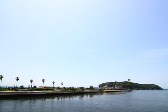A distant view of Enoshima Island in early summer, seen from the Kugenuma coastal side of the Enoshima Benten Bridge