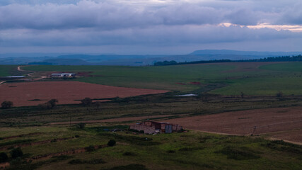 Fototapeta premium Dramatic African Landscape with Colorful Sky and Rural Fields